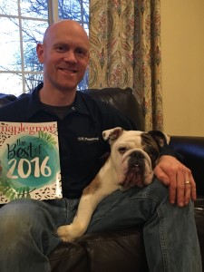 Owner TJ Knatcal with his dog and "Best Home Service 2016" award